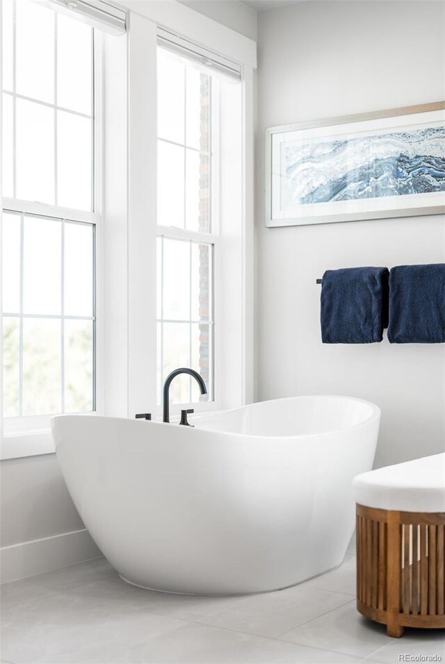 8357 W 68th Ln, Arvada, CO 80004 - bathroom featuring a freestanding bath, tile patterned floors, and a sink