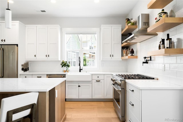 8357 W 68th Ln, Arvada, CO 80004 - kitchen with open shelves, appliances with stainless steel finishes, island exhaust hood, light wood-style floors, and recessed lighting