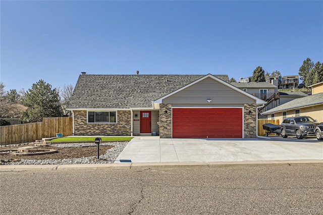 ranch-style home with fence, a shingled roof, brick siding, a garage, and driveway