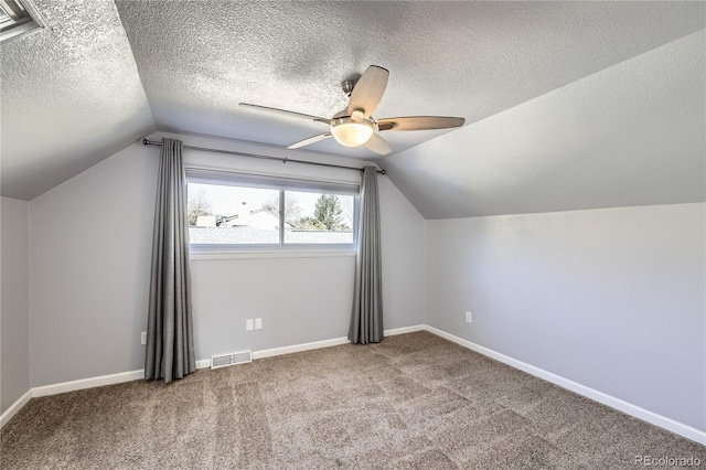 additional living space with visible vents, carpet, ceiling fan, and lofted ceiling