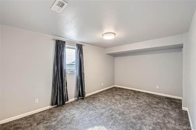 interior space with baseboards, carpet flooring, a textured ceiling, and visible vents