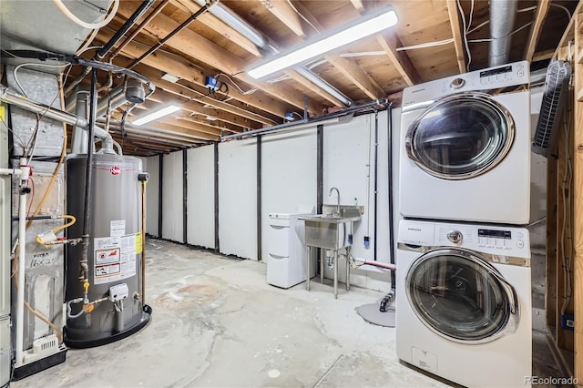 washroom with a sink, gas water heater, stacked washer / drying machine, and laundry area