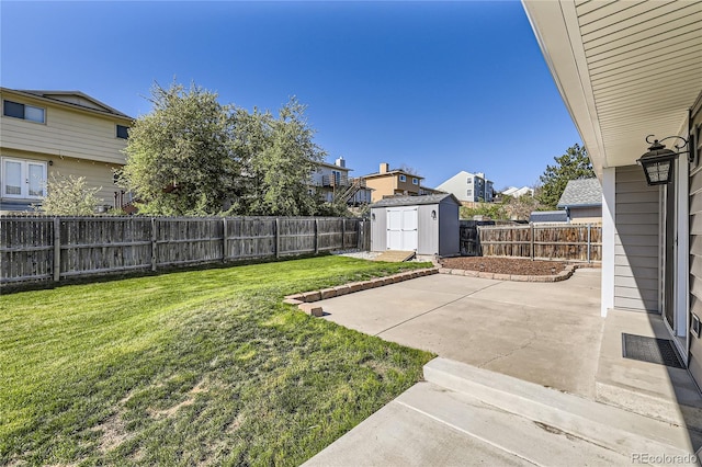 view of yard with a residential view, a patio area, an outdoor structure, a fenced backyard, and a storage unit