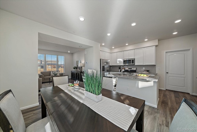 dining area with dark hardwood / wood-style floors