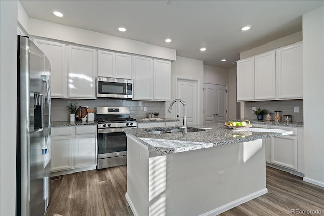 kitchen with stainless steel appliances, white cabinets, and sink