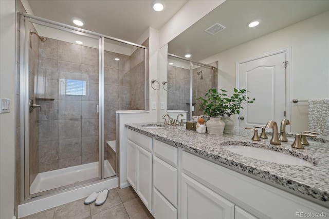 bathroom with vanity, tile patterned floors, and a shower with shower door