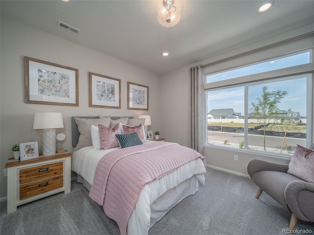 bedroom with dark colored carpet