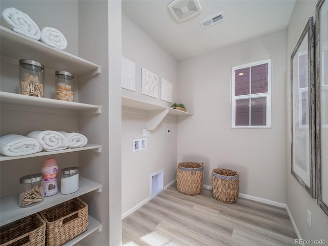 laundry room featuring washer hookup, hookup for an electric dryer, and light hardwood / wood-style flooring