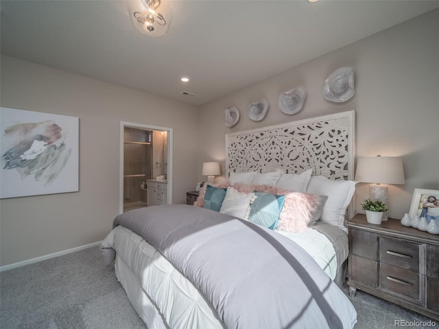 bedroom featuring ensuite bath and light colored carpet