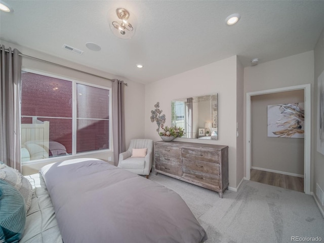 bedroom featuring light carpet