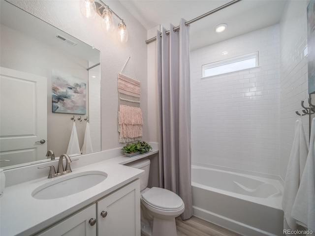 full bathroom with toilet, vanity, shower / bathtub combination with curtain, and hardwood / wood-style flooring