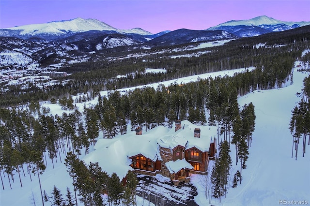 snowy aerial view featuring a mountain view