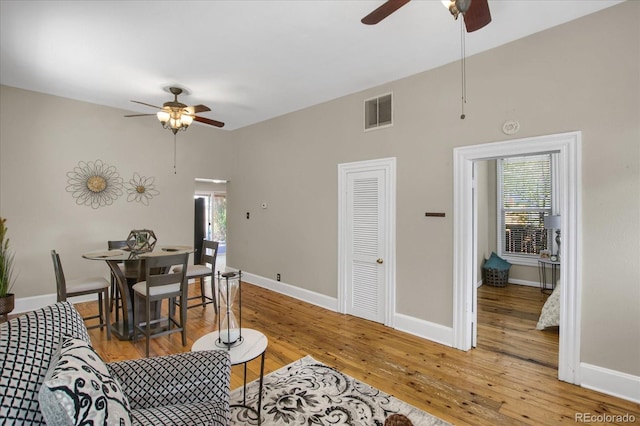 2415 Chase St, Edgewater, CO 80214 - living area with ceiling fan, plenty of natural light, wood-type flooring, and baseboards