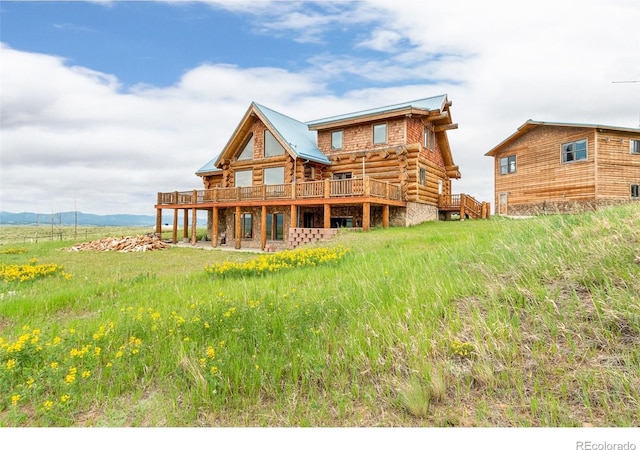 1000 N County Road 33, Como, CO 80432 - back of property featuring log exterior, a deck, and a metal roof