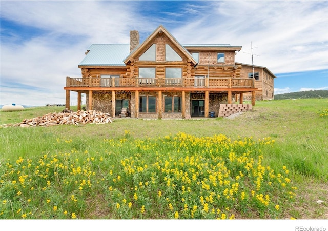 1000 N County Road 33, Como, CO 80432 - rear view of house featuring log siding, a chimney, stone siding, and a deck