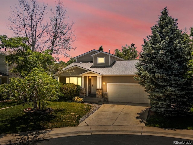 12555 Eastlake Dr, Thornton, CO 80241 - view of front of home featuring a garage, concrete driveway, stone siding, a lawn, and roof with shingles