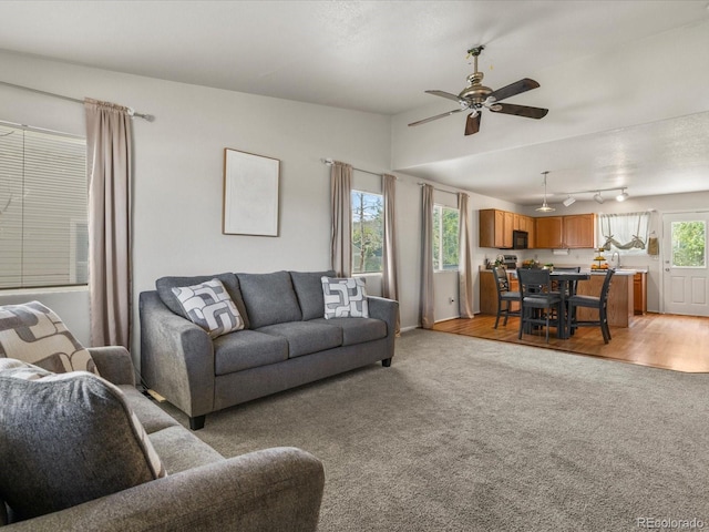 12555 Eastlake Dr, Thornton, CO 80241 - living room featuring light colored carpet, ceiling fan, and vaulted ceiling