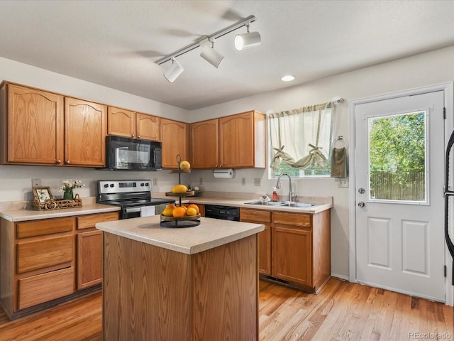 12555 Eastlake Dr, Thornton, CO 80241 - kitchen featuring black appliances, light countertops, rail lighting, and light wood-style flooring