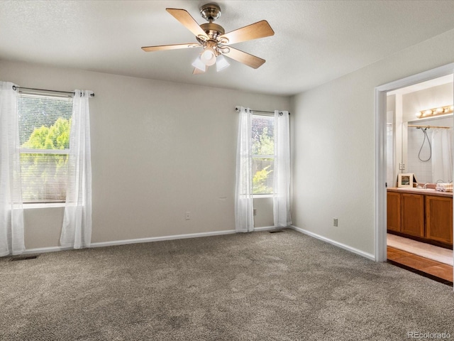 12555 Eastlake Dr, Thornton, CO 80241 - unfurnished bedroom with light carpet, ensuite bath, and ceiling fan