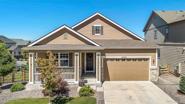 22891 E Union Cir, Aurora, CO 80015 - view of front of property with covered porch, driveway, and roof with shingles