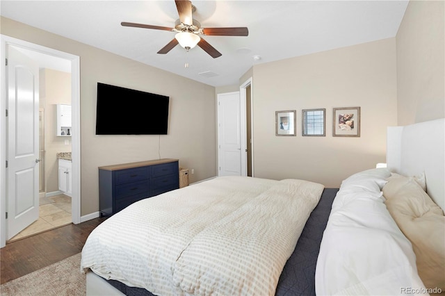 22891 E Union Cir, Aurora, CO 80015 - bedroom featuring wood finished floors, ensuite bathroom, and a ceiling fan