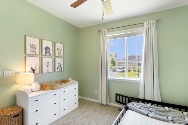 22891 E Union Cir, Aurora, CO 80015 - bedroom with a crib, multiple windows, light colored carpet, and ceiling fan