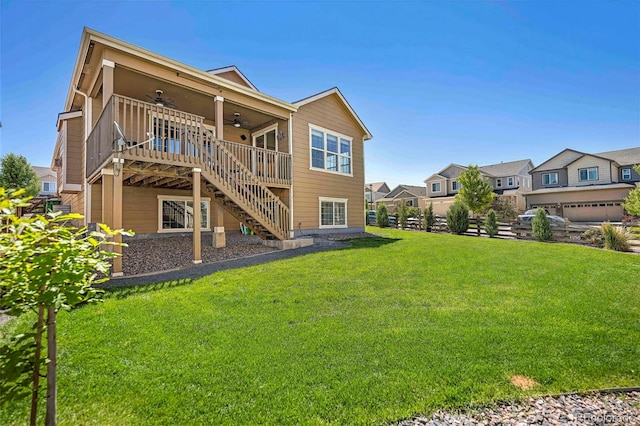 22891 E Union Cir, Aurora, CO 80015 - rear view of house featuring ceiling fan, stairway, a deck, and a lawn
