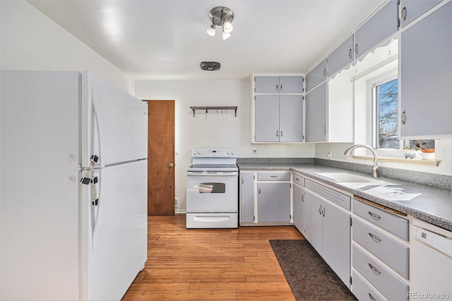 kitchen with white appliances, light hardwood / wood-style floors, sink, and gray cabinetry