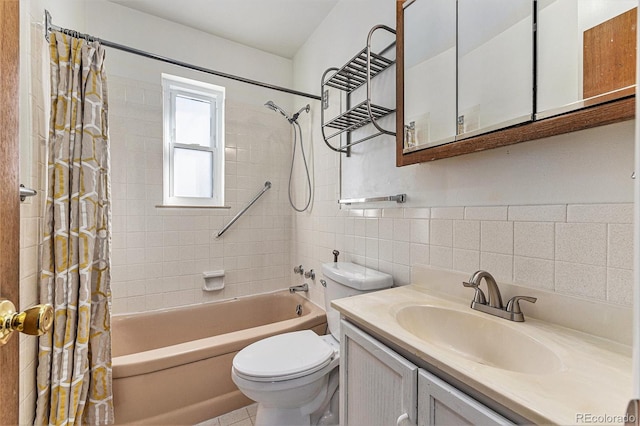 full bathroom featuring shower / bath combo with shower curtain, vanity, toilet, and tile walls