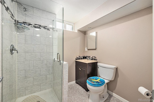 bathroom featuring vanity, tile patterned flooring, toilet, and walk in shower