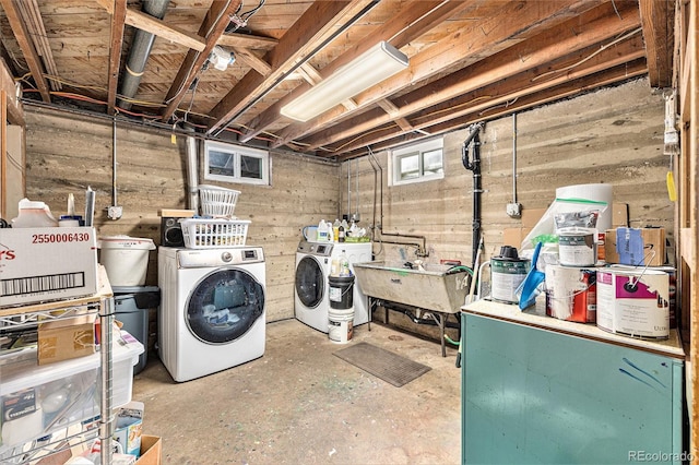 washroom with separate washer and dryer and sink