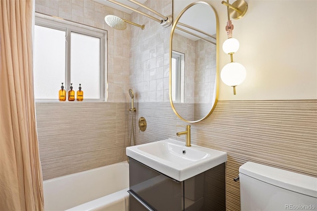 1335 Jasmine St, Denver, CO 80220 - full bathroom featuring shower / tub combo, tile walls, and vanity