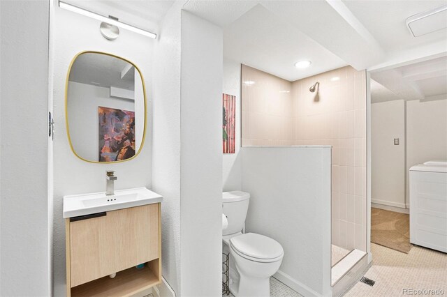 1335 Jasmine St, Denver, CO 80220 - bathroom featuring washer / clothes dryer, walk in shower, vanity, and tile patterned floors