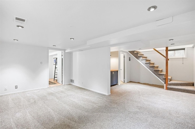 1335 Jasmine St, Denver, CO 80220 - below grade area with stairway, light carpet, and recessed lighting