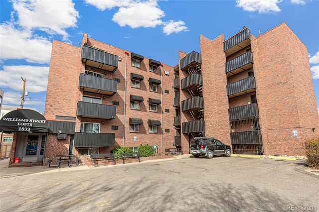view of building exterior featuring uncovered parking