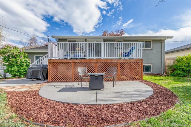 3841 W Quinn Pl, Denver, CO 80236 - back of property featuring a patio area, brick siding, a wooden deck, and a fire pit