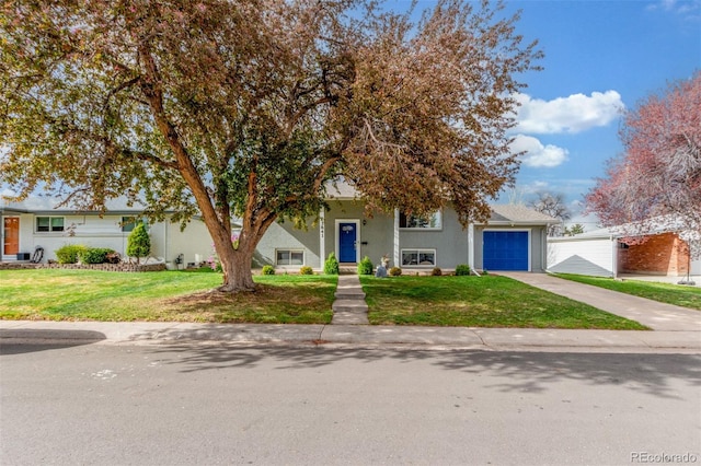 3841 W Quinn Pl, Denver, CO 80236 - view of front of property featuring driveway, an attached garage, a front lawn, and stucco siding