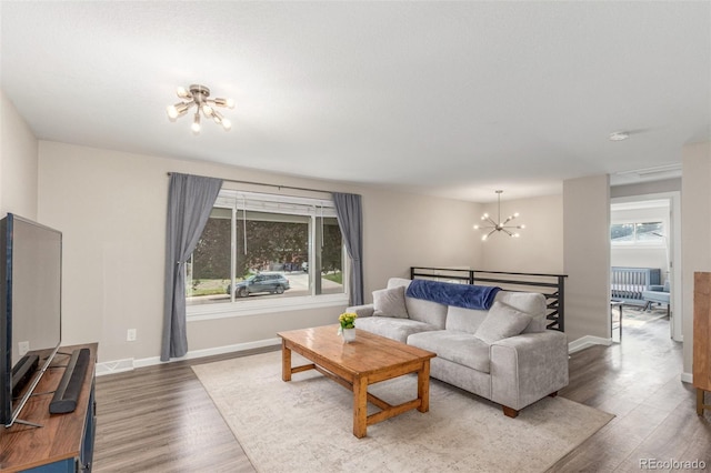 3841 W Quinn Pl, Denver, CO 80236 - living area featuring a chandelier and wood finished floors