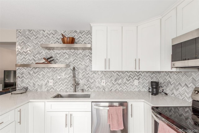 3841 W Quinn Pl, Denver, CO 80236 - kitchen with stainless steel appliances, light countertops, tasteful backsplash, open shelves, and white cabinetry