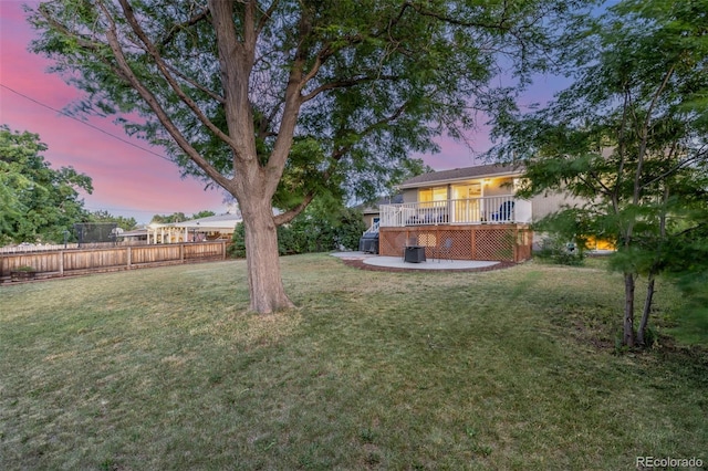 3841 W Quinn Pl, Denver, CO 80236 - yard at dusk with a deck and a patio area