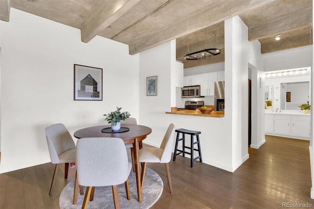 dining room with dark wood-type flooring and baseboards