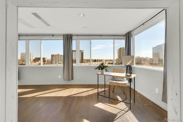 sunroom featuring a city view