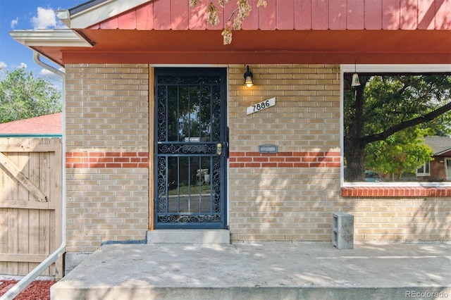 7886 Cyd Dr, Denver, CO 80221 - doorway to property with brick siding