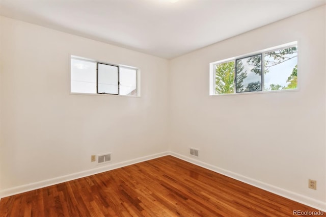 7886 Cyd Dr, Denver, CO 80221 - empty room with wood finished floors, baseboards, and visible vents