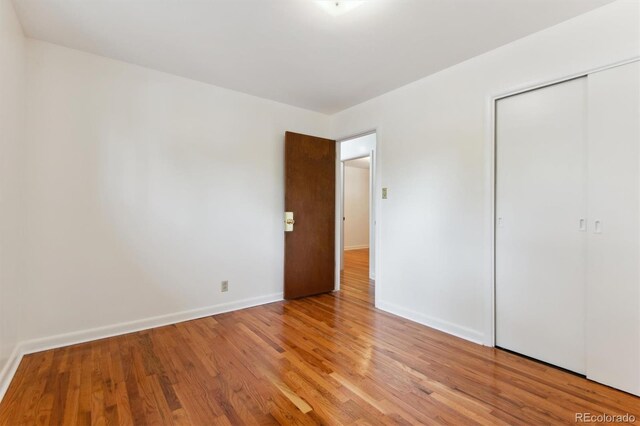 7886 Cyd Dr, Denver, CO 80221 - unfurnished bedroom with baseboards, a closet, and light wood-type flooring