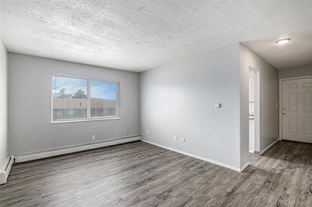 unfurnished room featuring dark wood-type flooring, a textured ceiling, and baseboard heating