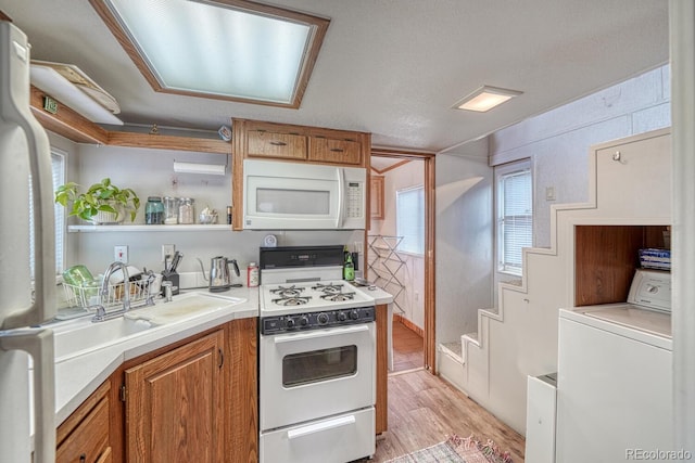 10795 County Road 197a Unit 184, Nathrop, CO 81236 - kitchen featuring white appliances, washer / dryer, light countertops, light wood-style floors, and plenty of natural light
