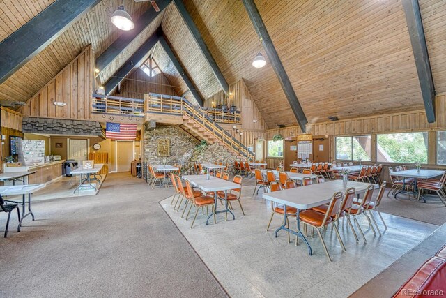 10795 County Road 197a Unit 184, Nathrop, CO 81236 - dining space featuring high vaulted ceiling, a wood ceiling with exposed beams, wood walls, and carpet floors