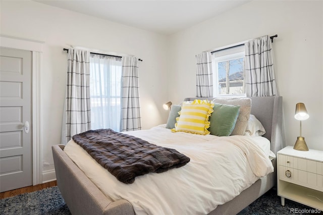 bedroom with dark wood finished floors