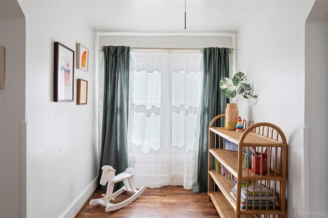 doorway to outside with baseboards and wood finished floors